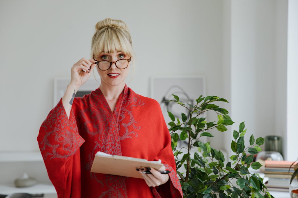 Woman Wearing Red Robe Holding a Chart